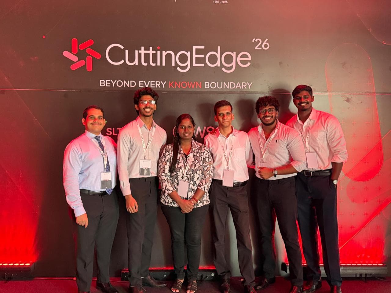 The team in front of the Cutting Edge ā26 backdrop